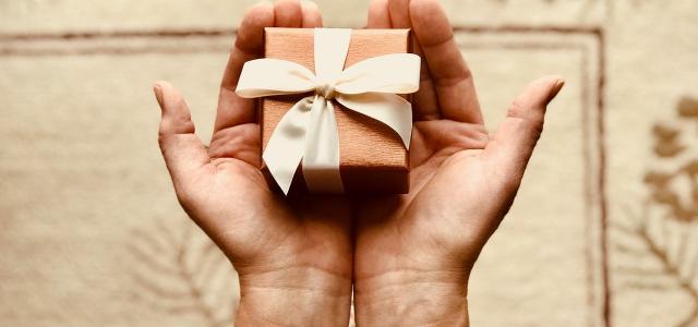 Hands holding a small wrapped present